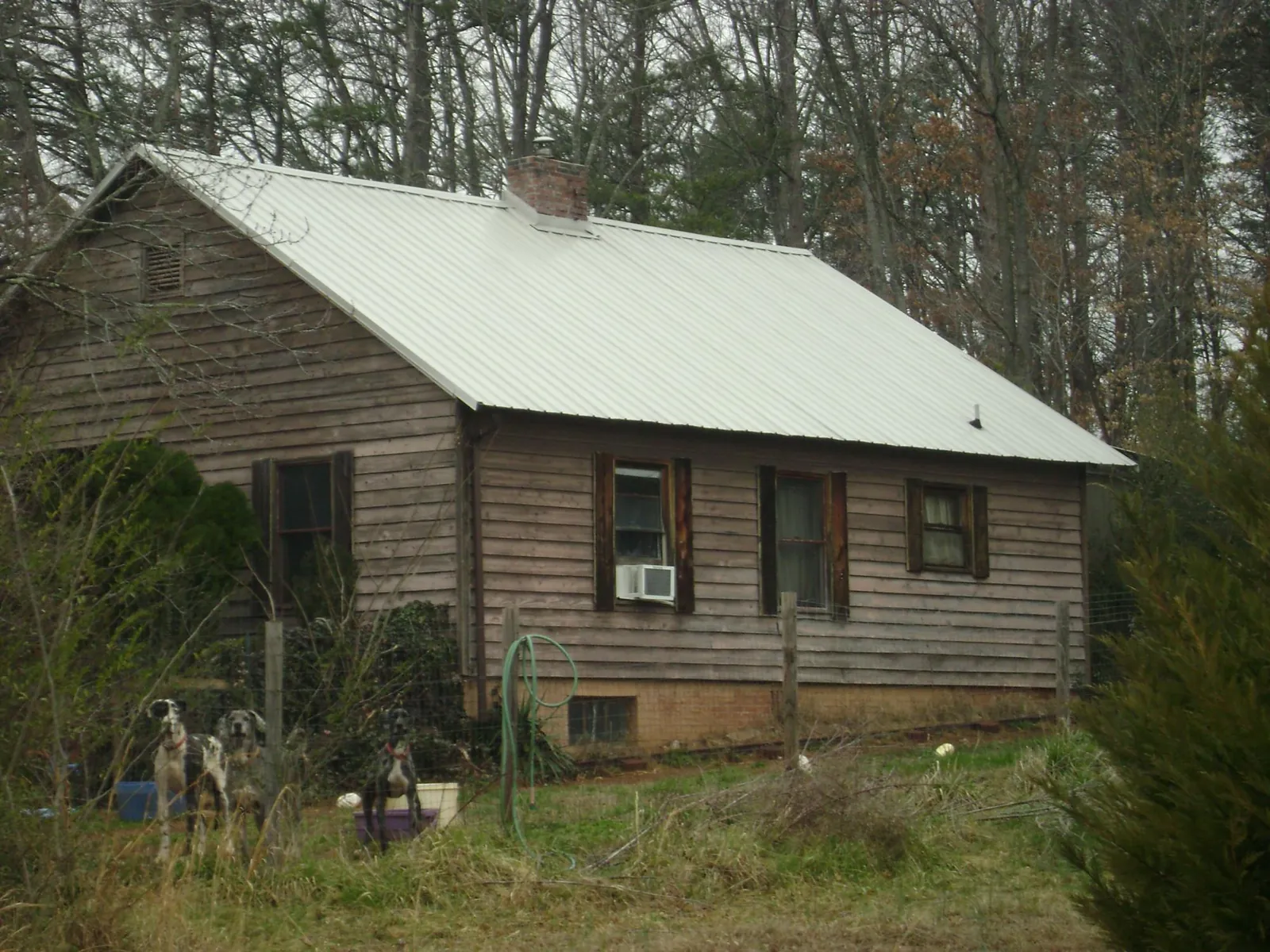 White metal roof on an old wood sided farmhouse, from a Metal Roof Installation job in East Marion